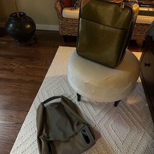 Pristine Louis Vuitton Olive suitcase with protective cover for traveling!